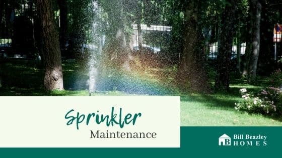 An image of sprinklers on in green grass.